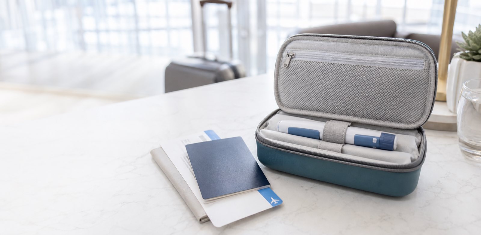 Prescription injection pen secured in a travel case beside a passport and boarding pass
